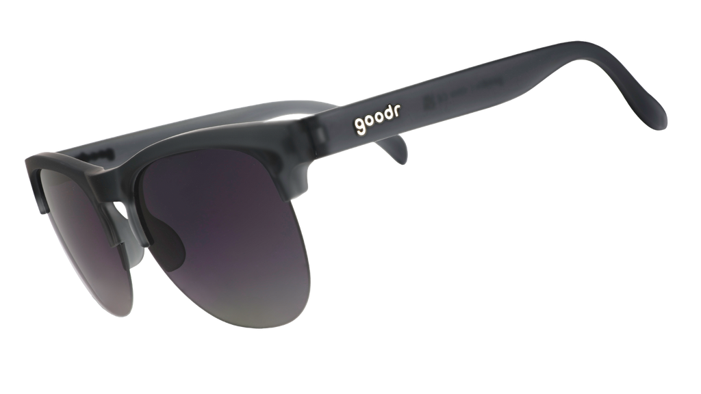 Three-quarter angle view of gray translucent half-rim sunglasses featuring gradient gray lenses.