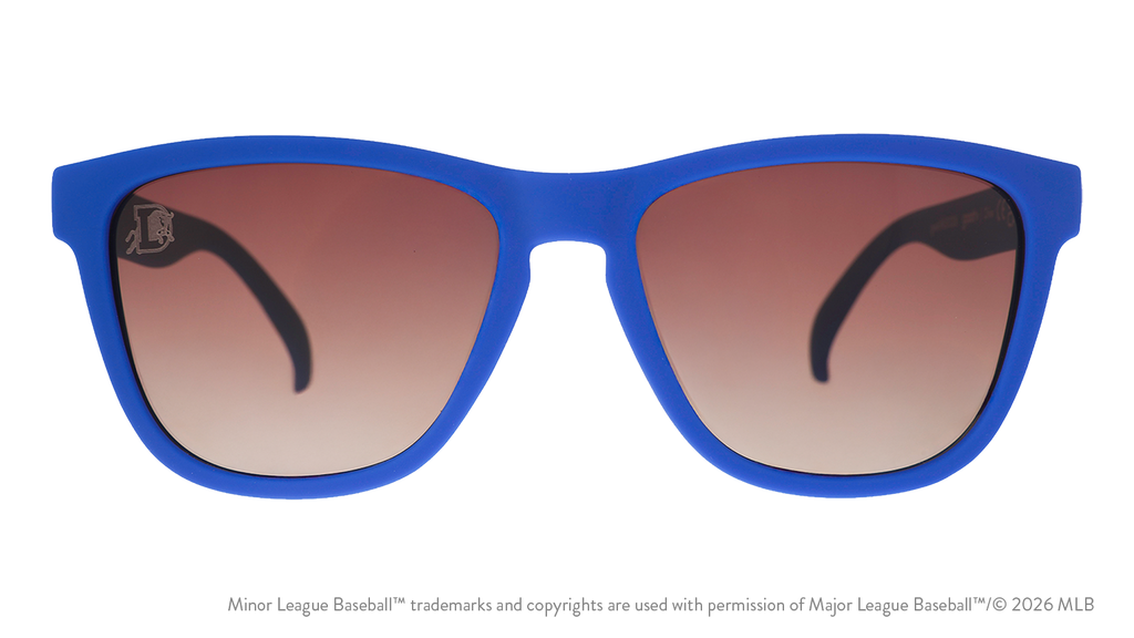 Front view of sunglasses. Blue front frame. Brown gradient lenses. Durham Bulls logo etching in top corner of lens.