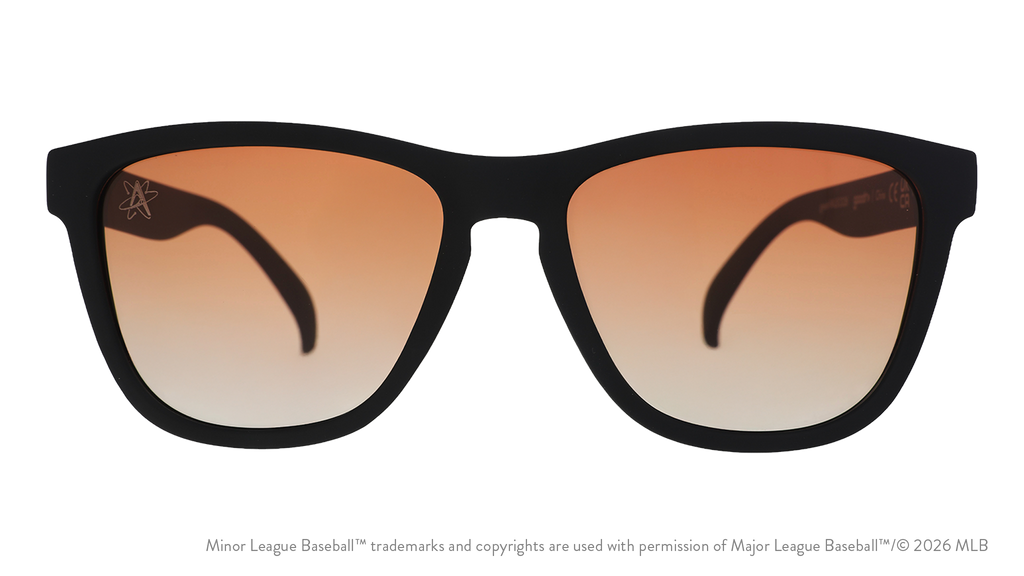 Front view of sunglasses. Black front frame. Amber reflective lenses. Isotopes logo etching in top corner of lens.