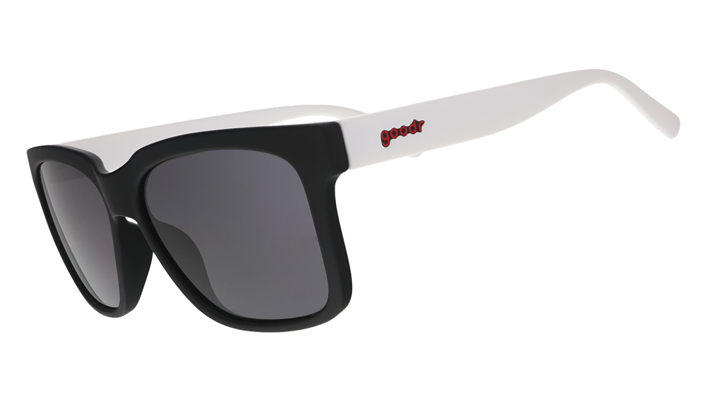Side view of black square sunglasses with black lenses, black frames, and white arms.