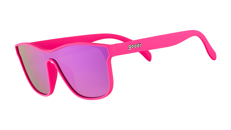 Three-quarter angle view of futuristic hot pink sunglasses with a flat purple single lens.