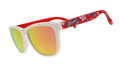 A pair of "goodr" sunglasses with white frames and reflective orange-gold lenses. The arms of the sunglasses are red and feature the University of Wisconsin’s mascot, Bucky Badger, along with bold "W" logos and other school-themed graphics.