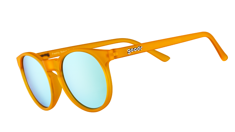 Three-quarter angle view of round orange sunglasses with light blue reflective polarized lenses.