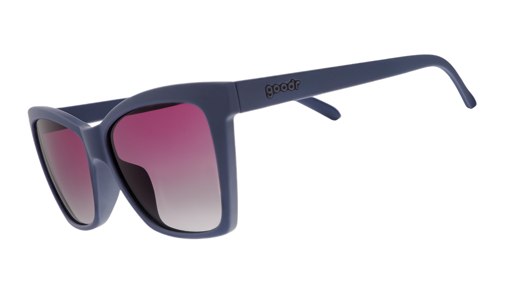 Three-quarter angle view of dark purple angular sunglasses with purple gradient lenses.