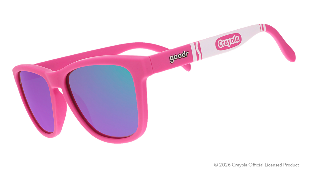 Three-quarter angle view of magenta shades w/ white Crayola marker pattern+purple pink reflective lenses tilted down.