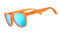 Three-quarter angle view of translucent bright orange sunglasses with blue reflective lenses on a white background.