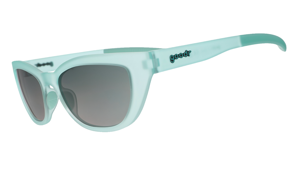 Three-quarter angle view of translucent pale green Cheetah G sunglasses with green gradient lenses.