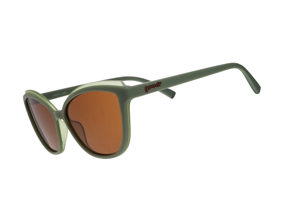 Green sunglasses with brown lenses on a white background
