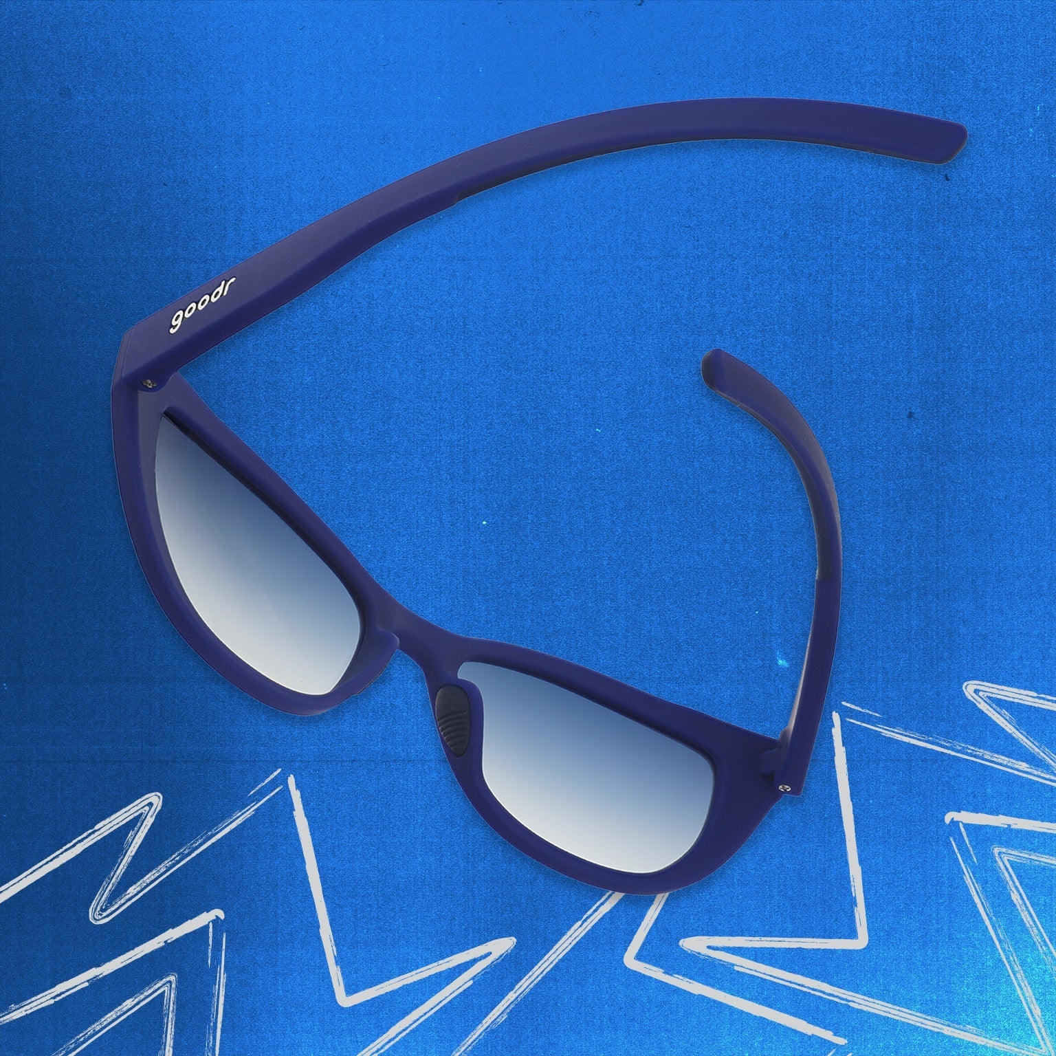 Back view of navy blue cat eye shades with blue gradient lenses tilted down on a blue background.