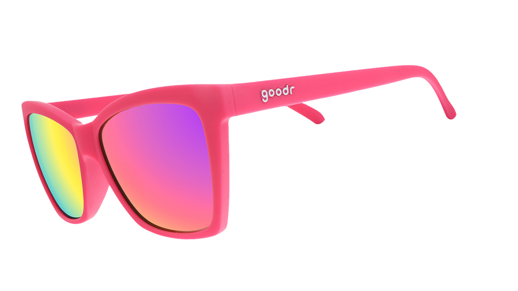 Three-quarter angle view of hot pink angled cat-eye sunglasses with pink reflective lenses.
