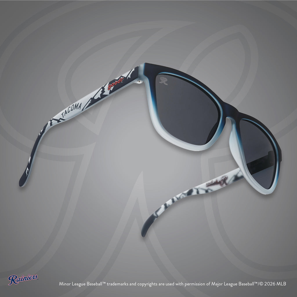 Three-quarter angle view of shades. Gray frames w/ mountain pattern, Tacoma on temples + black non-reflective lenses.