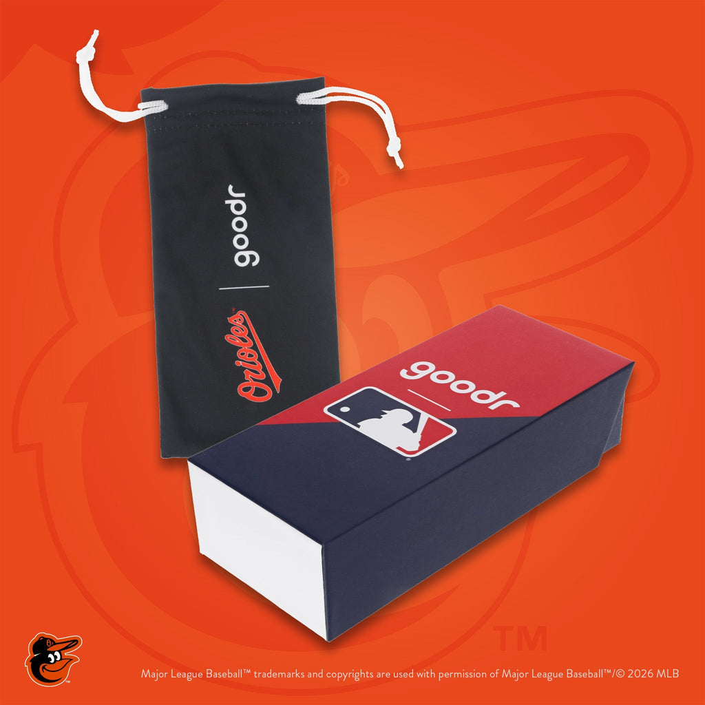 Photograph of custom packaging, featuring a black microfiber bag with Orioles script logo and MLB-themed product box.