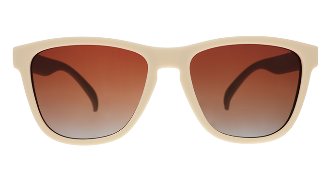 A pair of square sunglasses with light beige frames and orange lenses.
