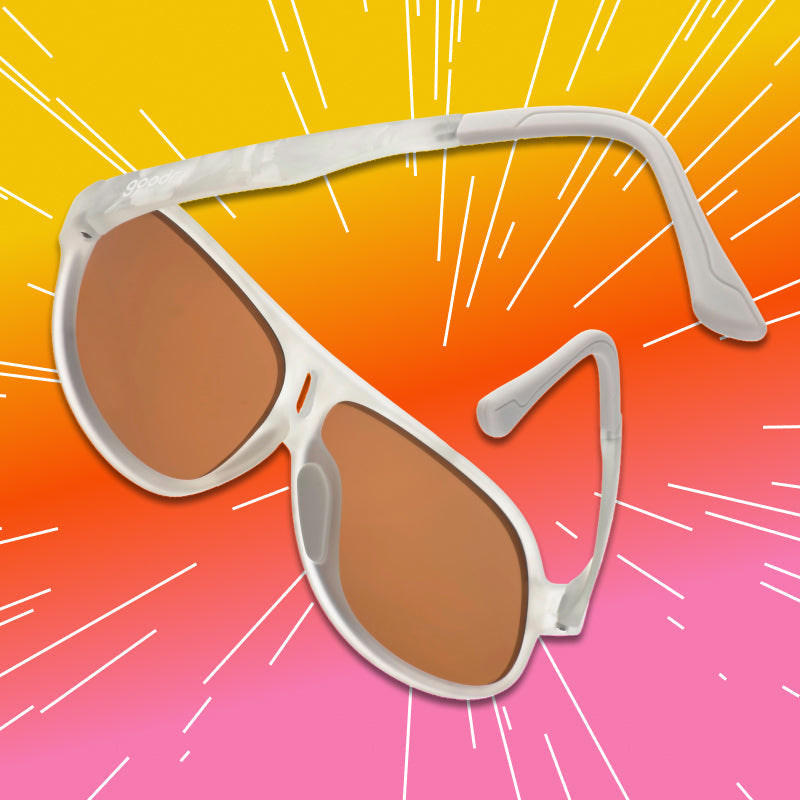 Angled view of aviator sunglasses with a translucent white frame and brown non-reflective lenses.