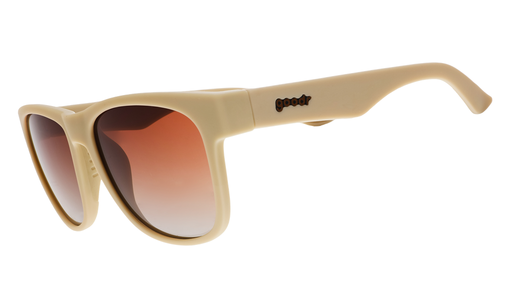A pair of square sunglasses with tan frames and burnt orange lenses.