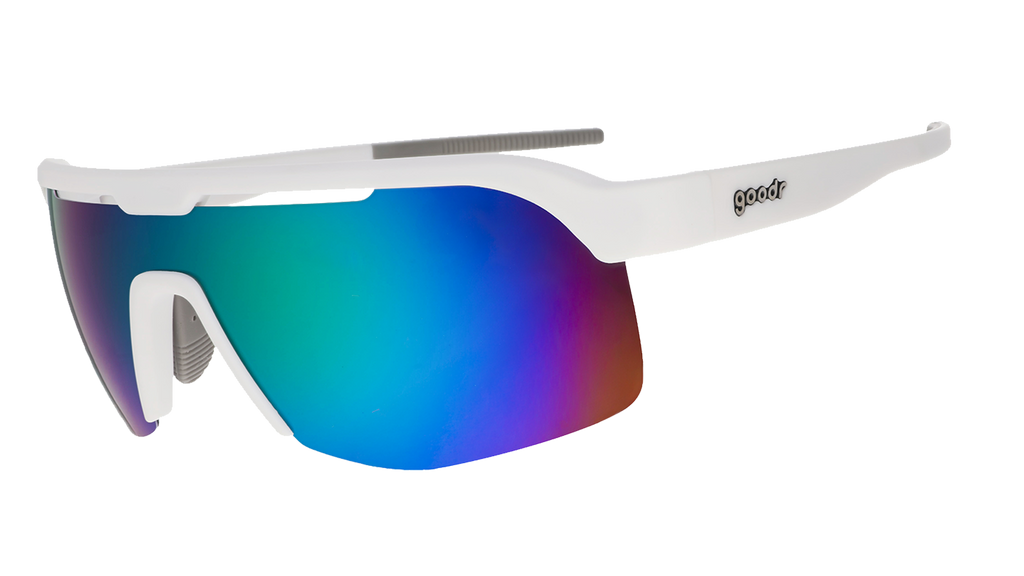 Three-quarter angle view of white shield sunglasses with green reflective wrap lenses tilted down on a white background.