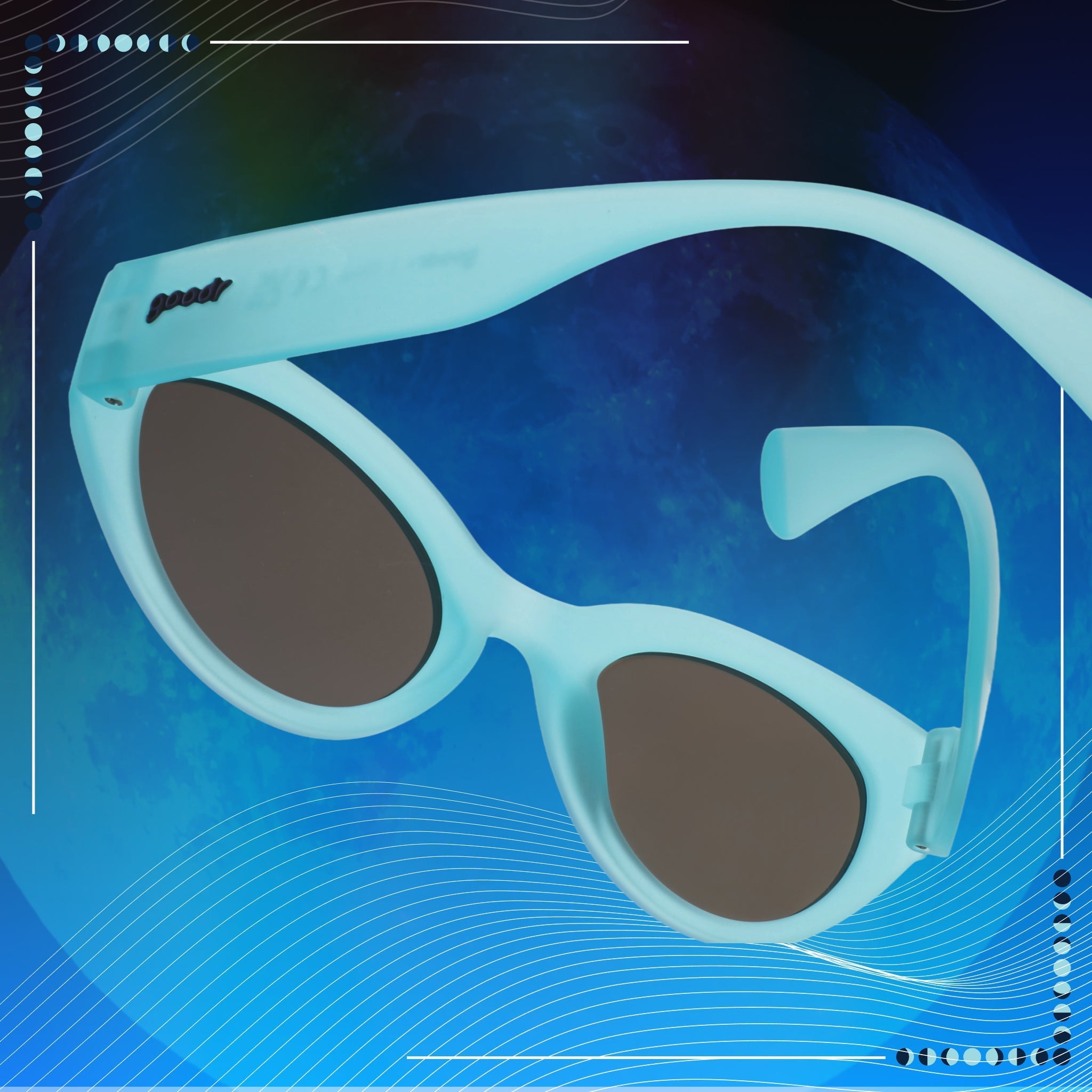 Light blue Moon Gs with blue reflective lenses on a blue moon backdrop. A badge in the corner informs that they glow in the dark.