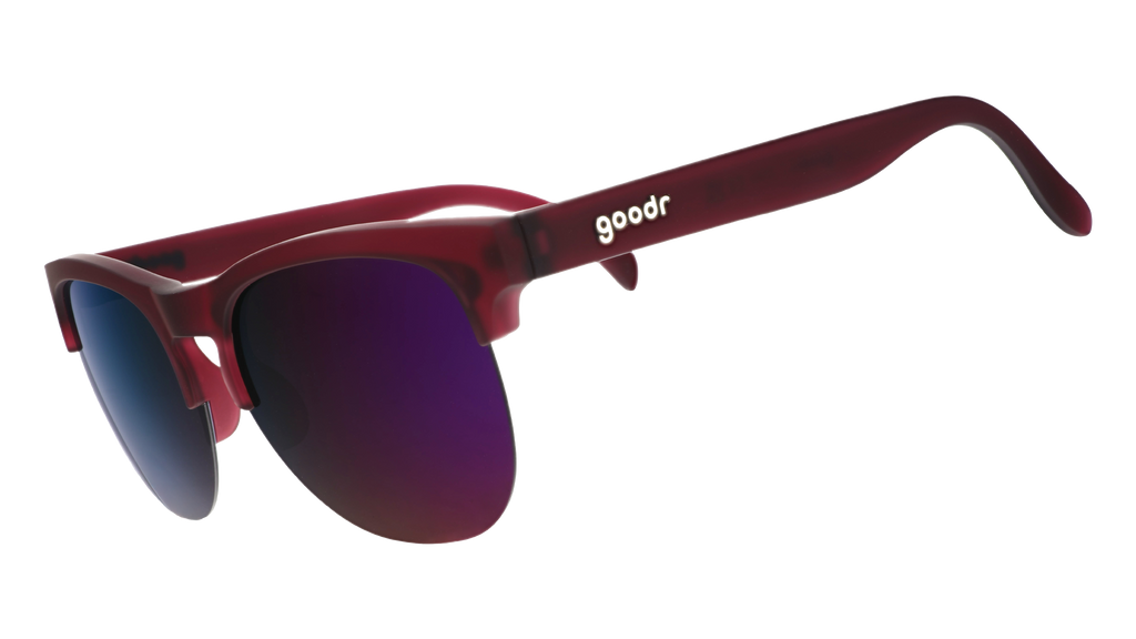 Three-quarter angle view of translucent purple half-rim sunglasses with purple reflective lenses.