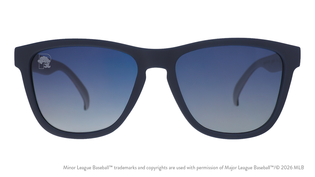 Front view of sunglasses. Dark blue front frame. Blue gradient lenses. Sea Dogs logo etching in top corner of lens.