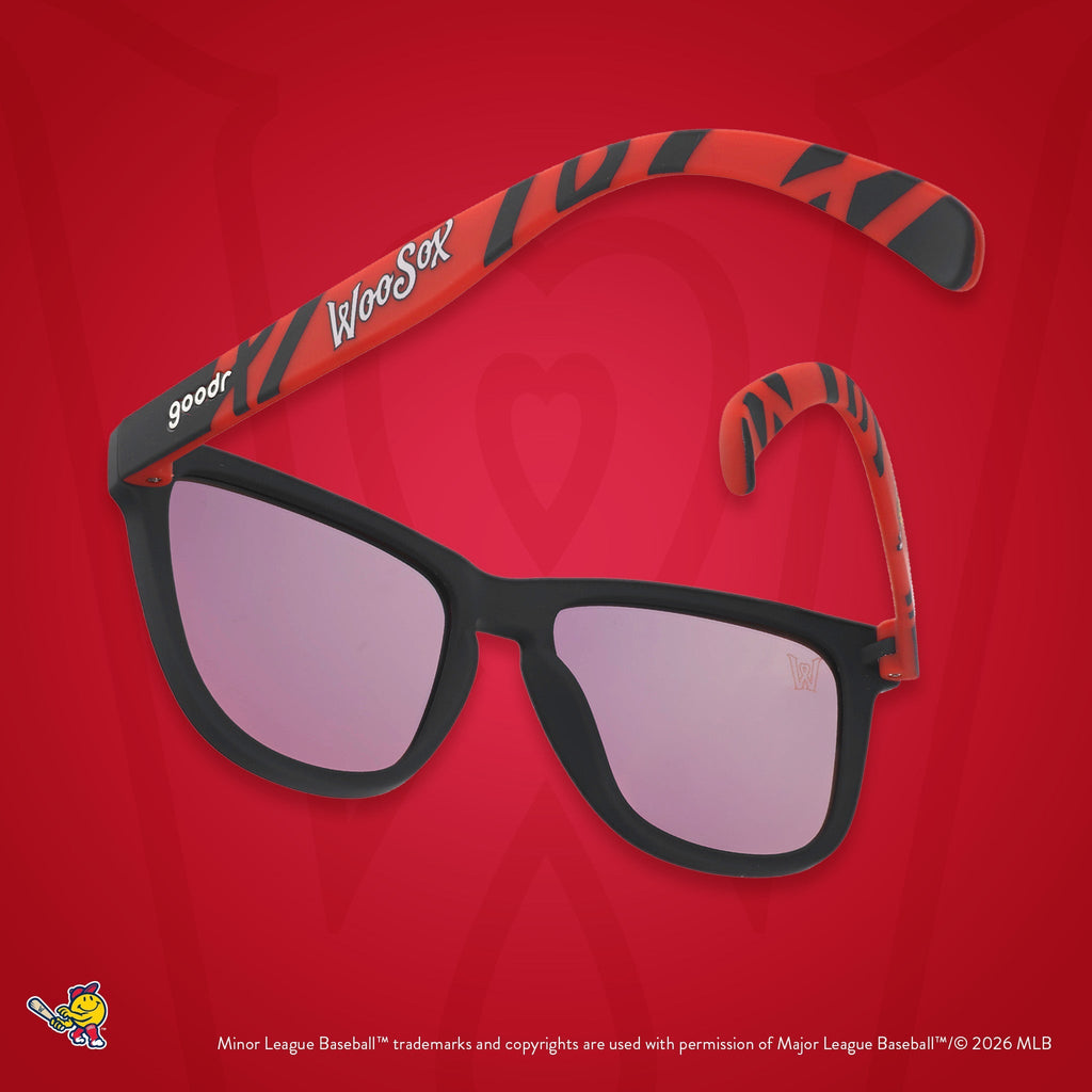 Back view of sunglasses. Dark blue frames w/ a red pattern, WooSox on temples + amber reflective lenses.