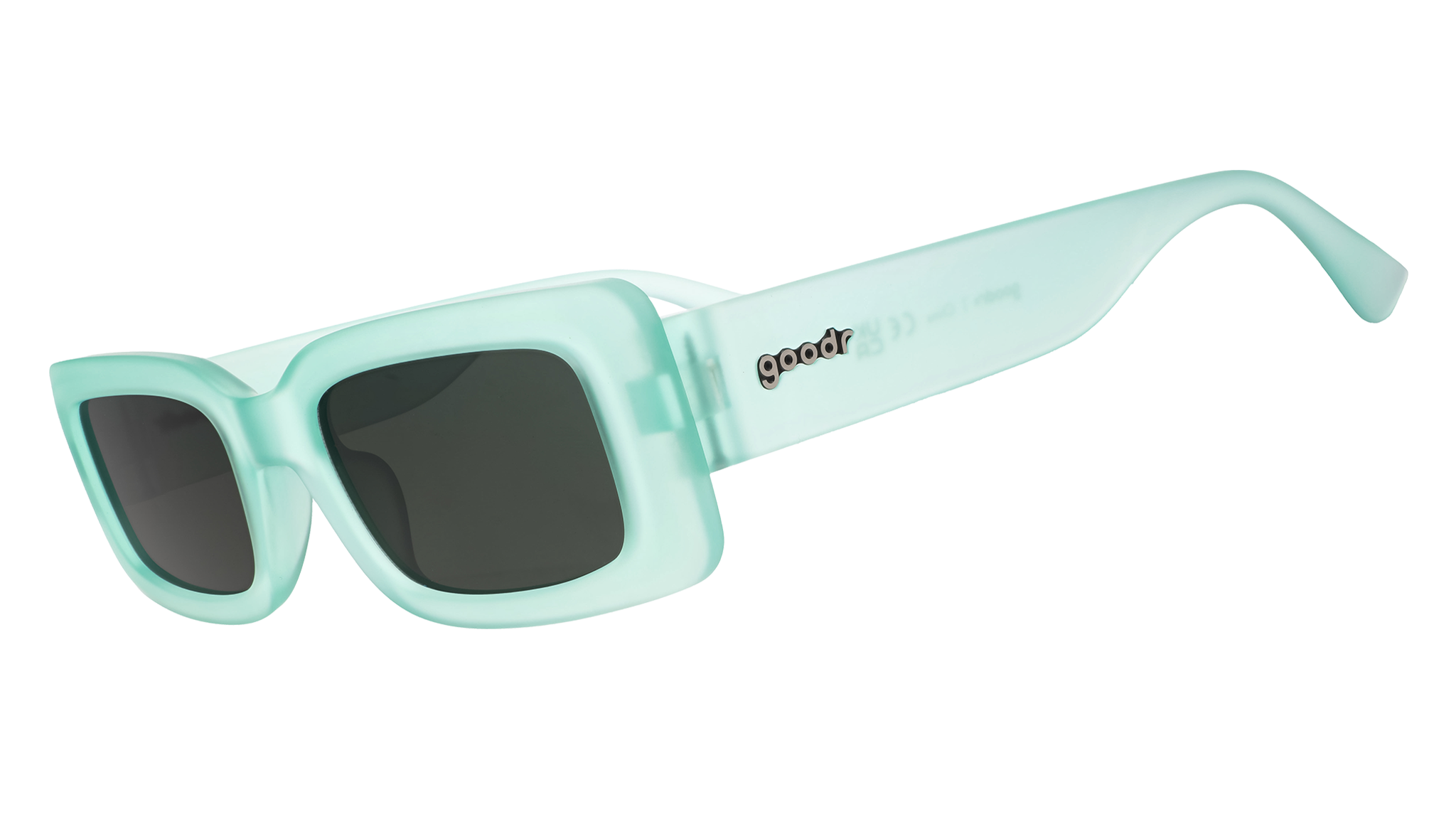 Three-quarter angle view of translucent light green rectangular sunglasses with green lenses.
