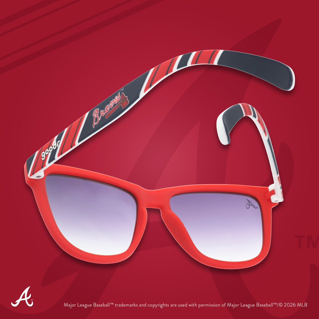 Red, white, and navy Braves shades photographed from behind, floating against a red background featuring the A logo.
