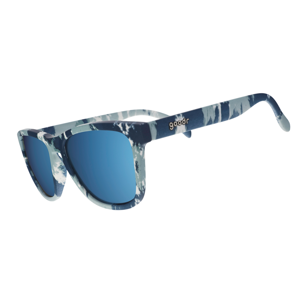 Three-quarter angle view of tonal blue on blue tie-dye sunglasses in a classic frame shape with ice blue reflective lenses.